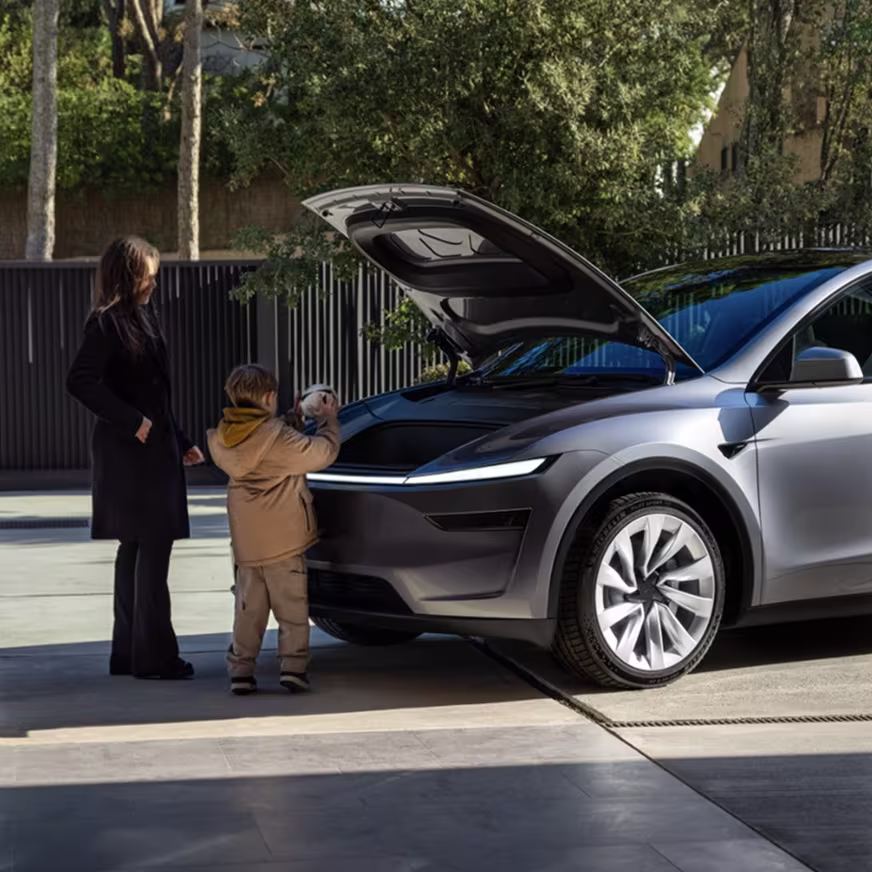 Woman and child in front of a Model Y with the frunk open